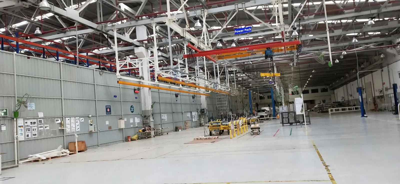 Wide assembly hall with overhead crane runways along the roof