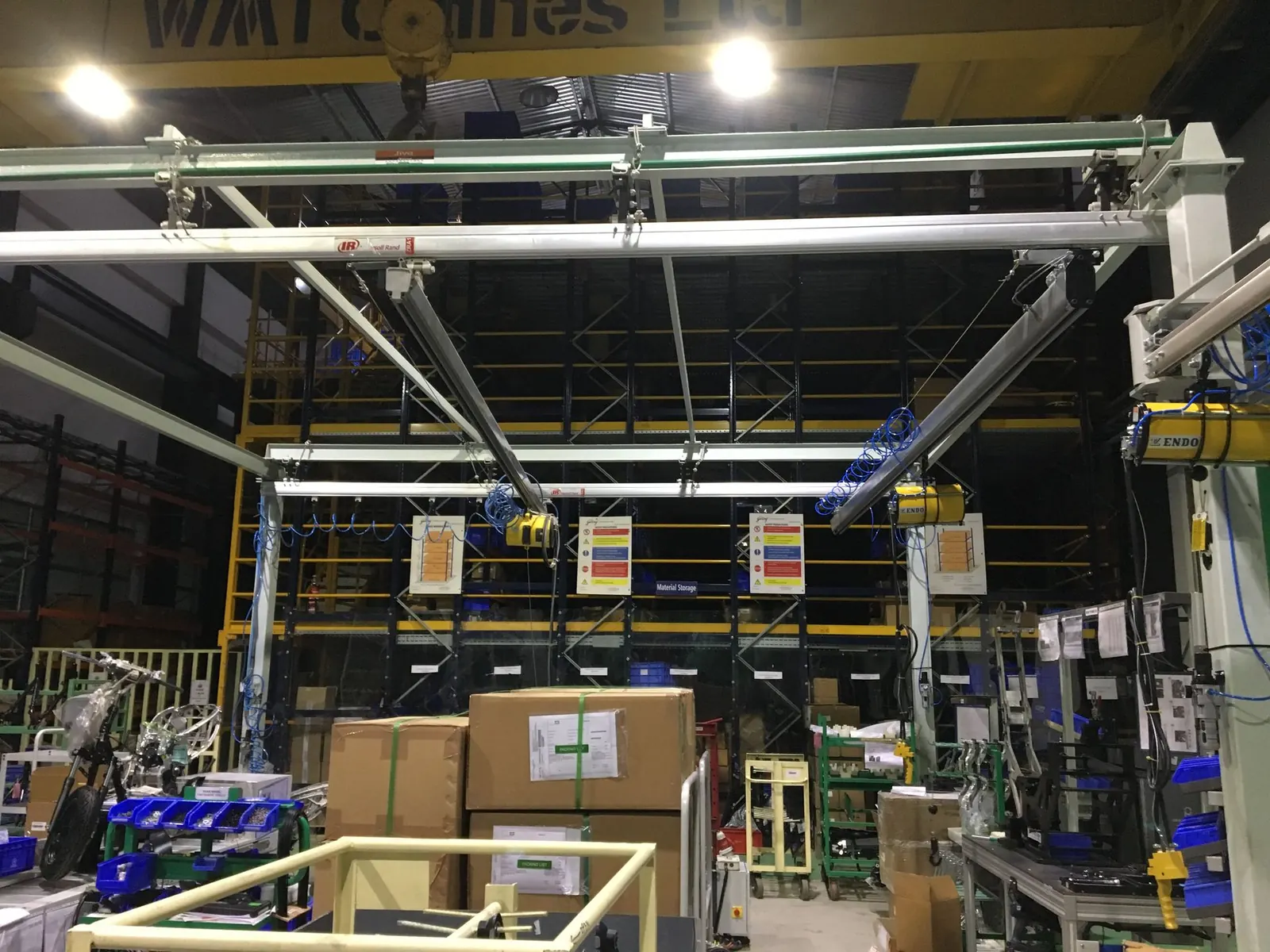 Overhead light-rail system with hoists above an assembly workstation