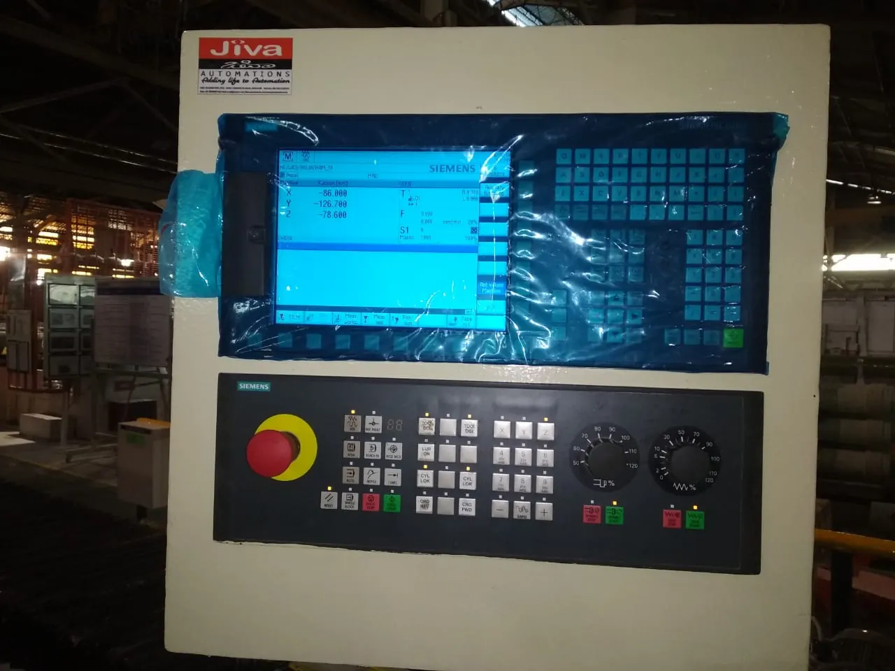 Siemens CNC operator panel with screen and keypad fitted in a JIVA control cabinet