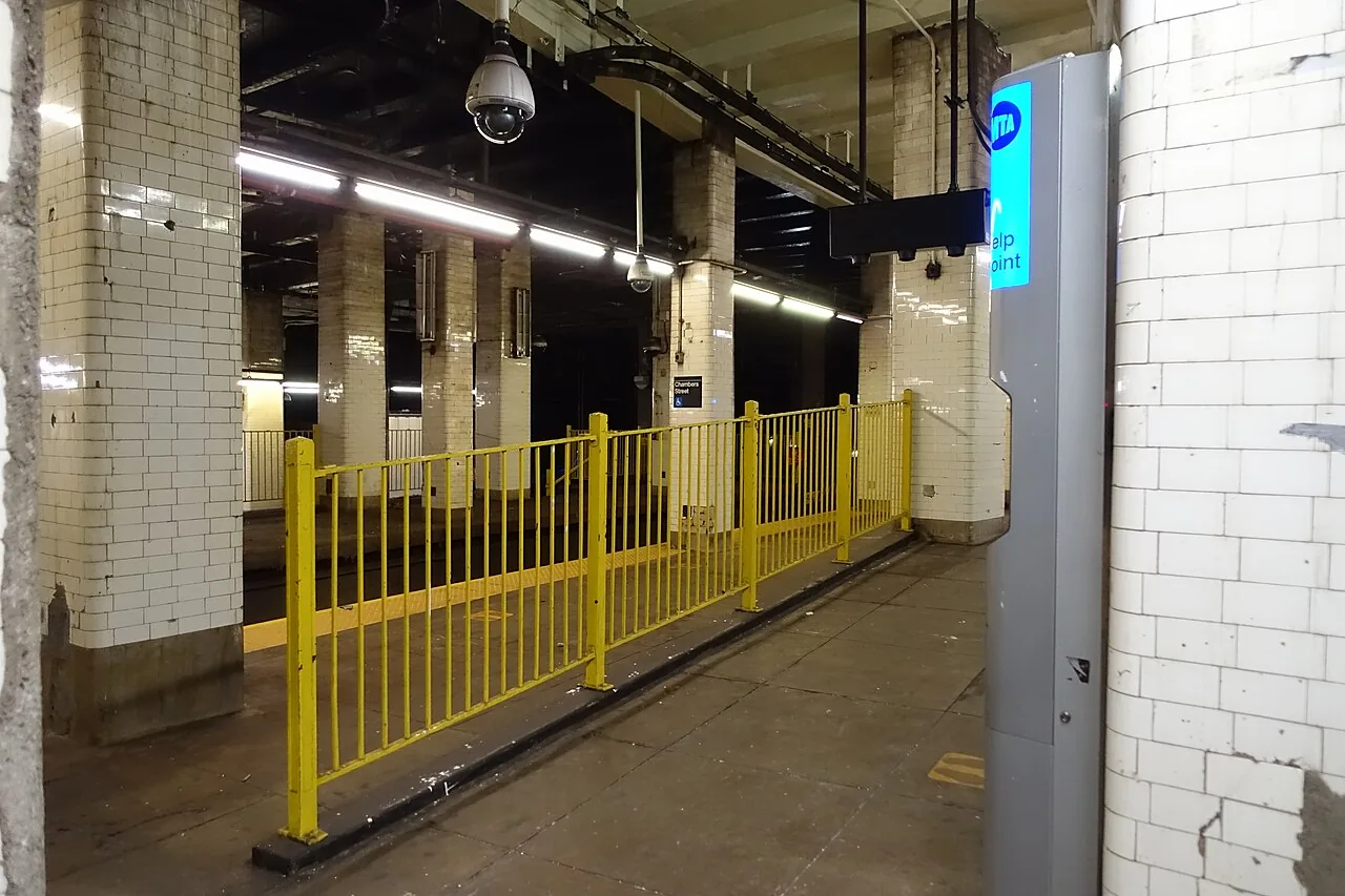 Dome security camera above a barrier in an underground station passage